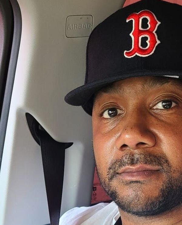 Sincere, wearing a Boston Red Sox, smiled warmly at the camera