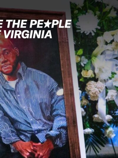A painting of a black man is stood next to a bouquet of white flowers.