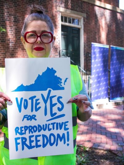Heather at the Virginia's capitol holding a sign that says "Vote yes for repro freedom!"