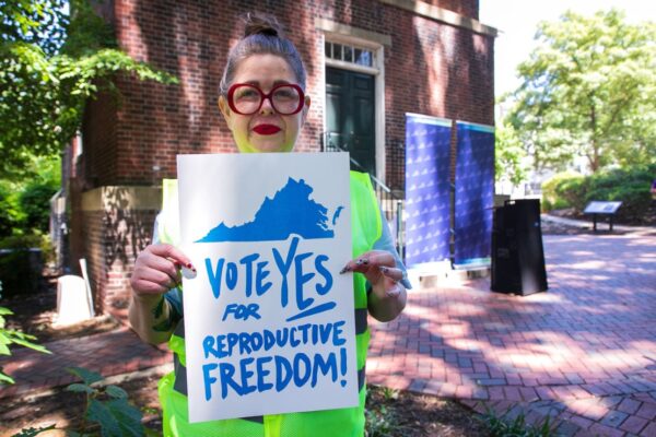 Heather at the Virginia's capitol holding a sign that says "Vote yes for repro freedom!"