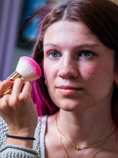 Eliza putting on make up