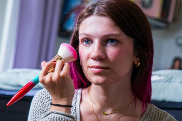Eliza putting on make up