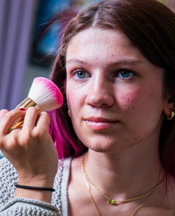 Eliza putting on make up