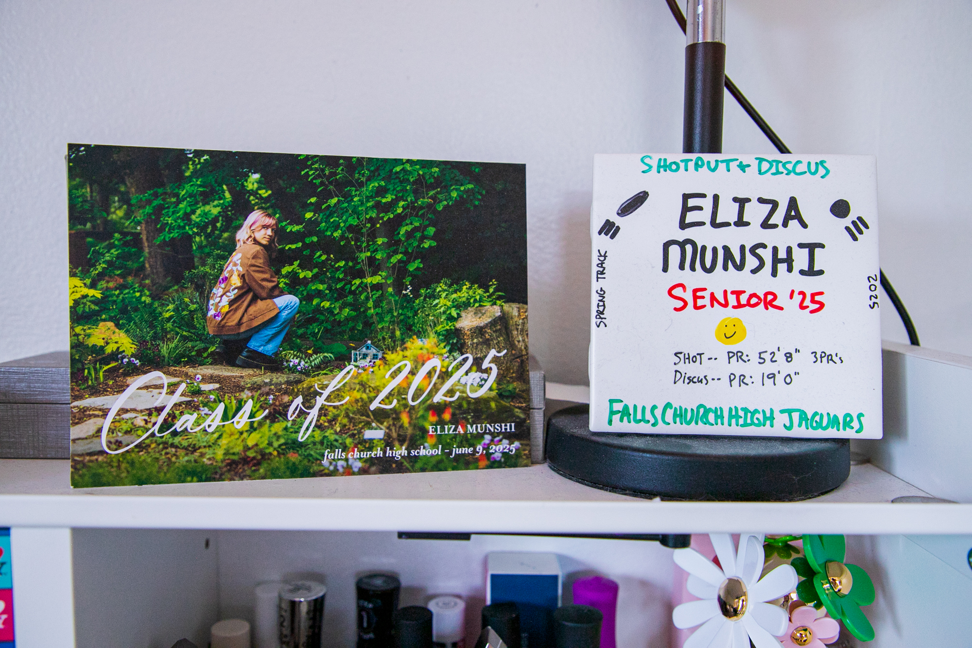 Memorabilia from Eliza's high school sitting on her bookshelves