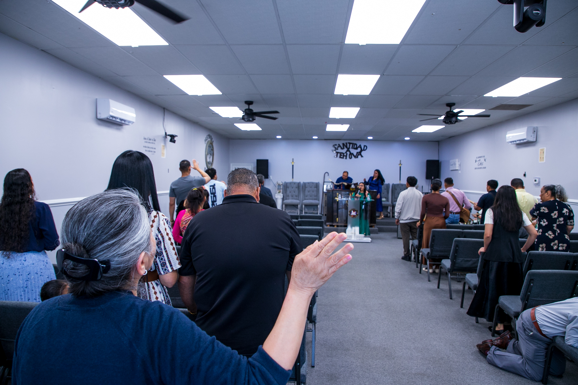 church goers sing in unison during service