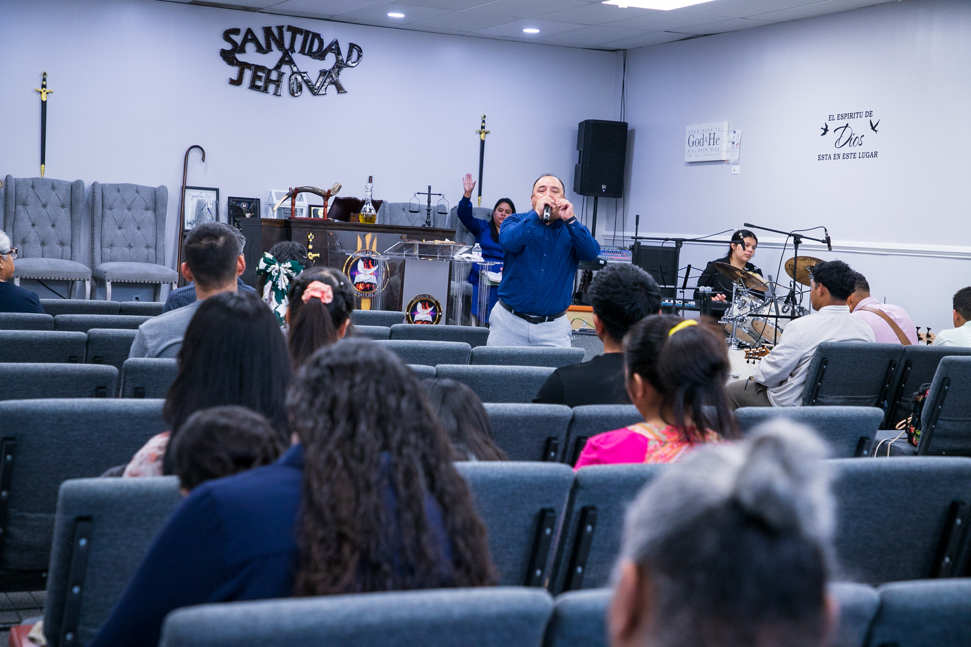 Pastor Manuel walked among his members during service