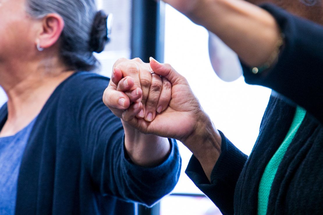 people holding hands during prayer