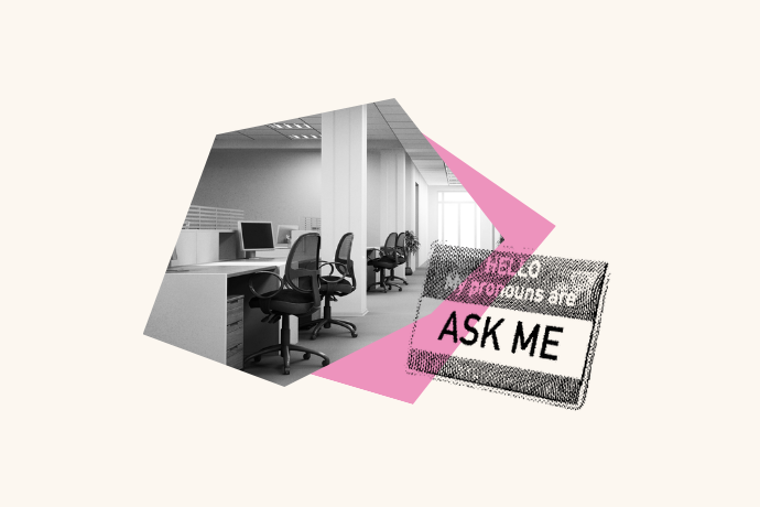 In a large room there is a row of office desks are empty. Over top the photo is a pronouns name tag that says "Hello my pronouns are: ASK ME."