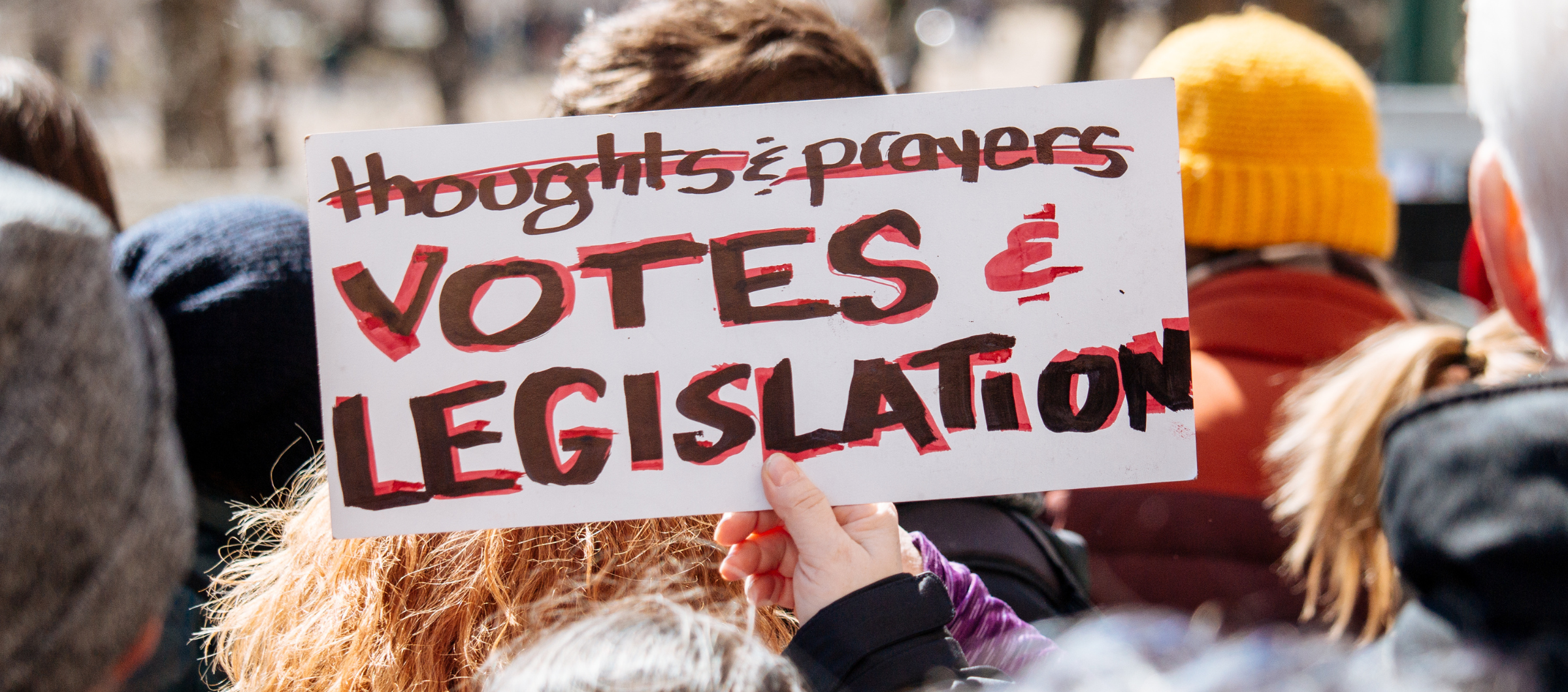 photo of a protest sign with the text "Votes & Legislation" 