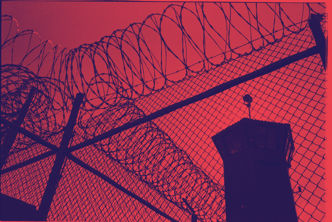 a picture of barbed wire and a prison watch tower