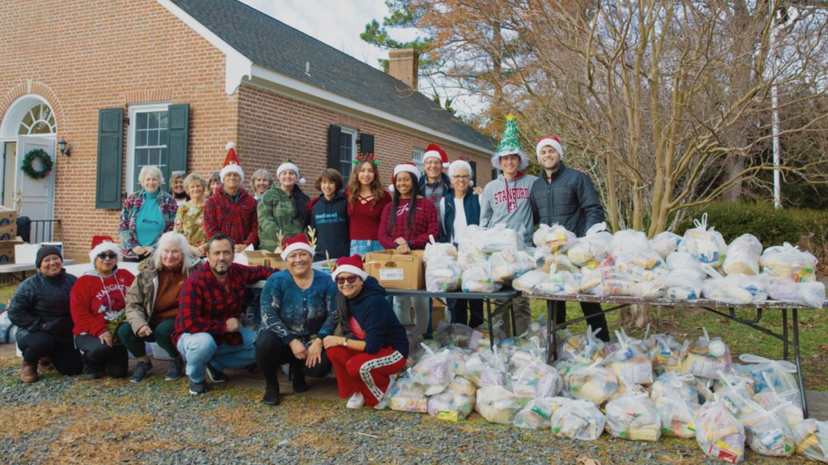 Volunteers from Dos Santos posed next to a bunch of gift bags they prepared