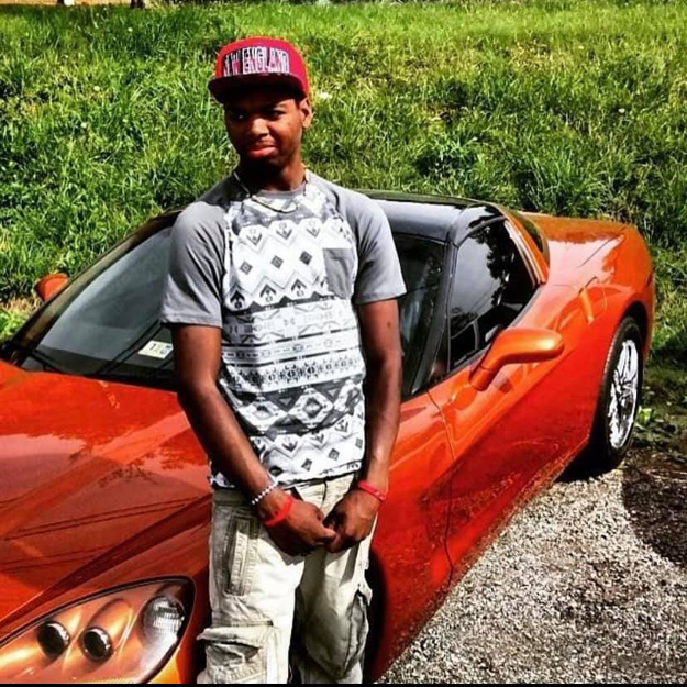 photo of Kionte Spencer leaning against a red sport car. He was shot dead by police in 2016.