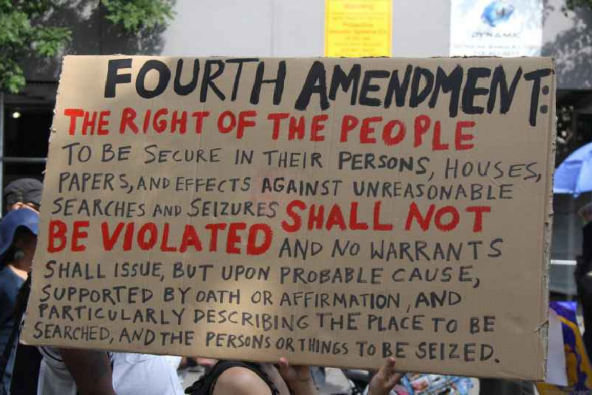 a protest sign with the fourth amendment written out on it