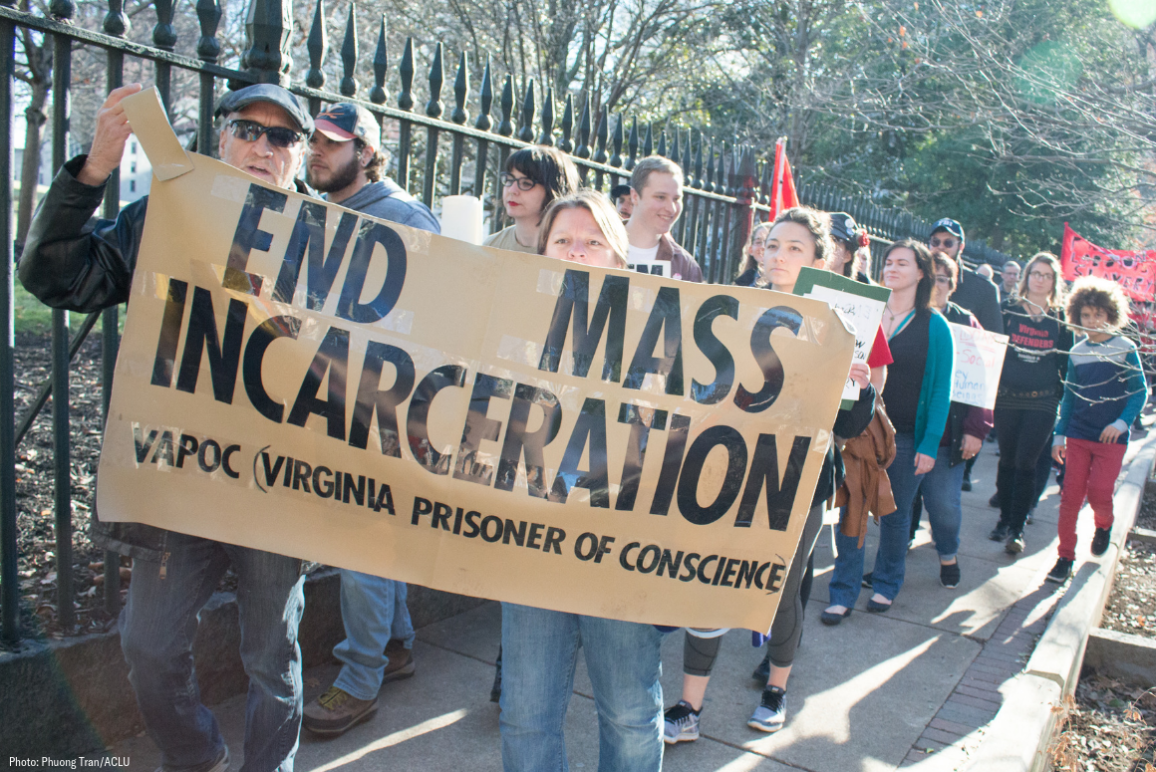 Protesters holding sign that says "End Mass Incarceration - VAPOC Virginia Prisoner of Conscience"