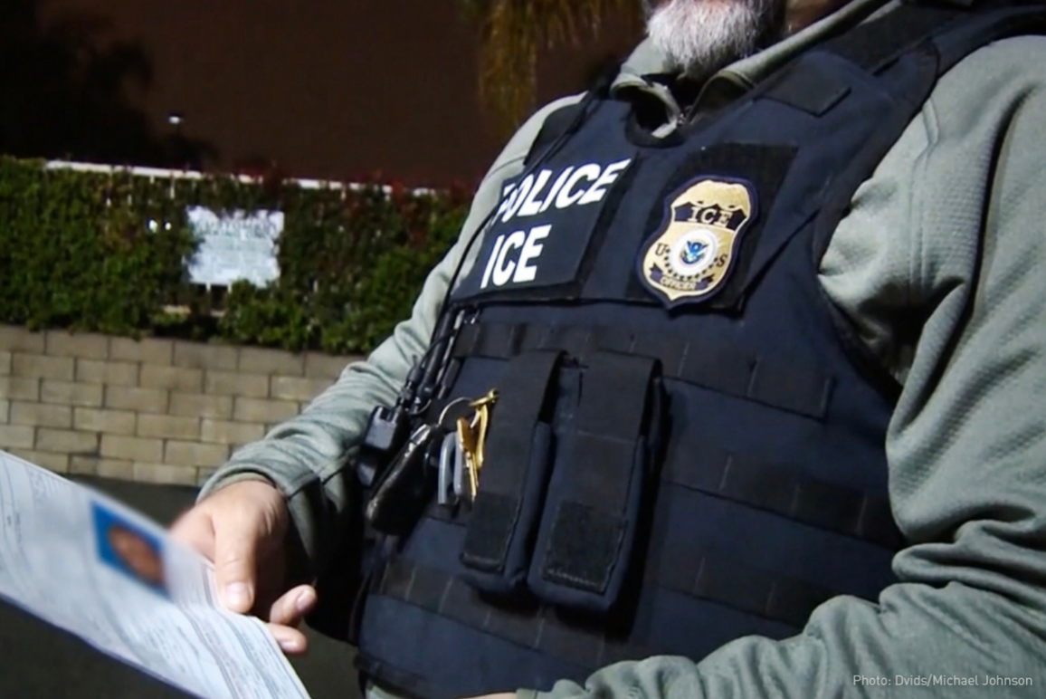ICE agents holding a piece of paper 