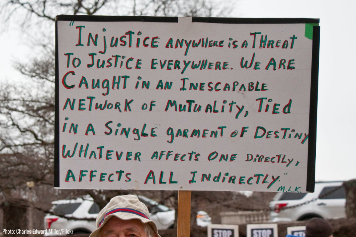 a sign quoting Martin Luther King "injustice anywhere is a threat to justice everywhere..."