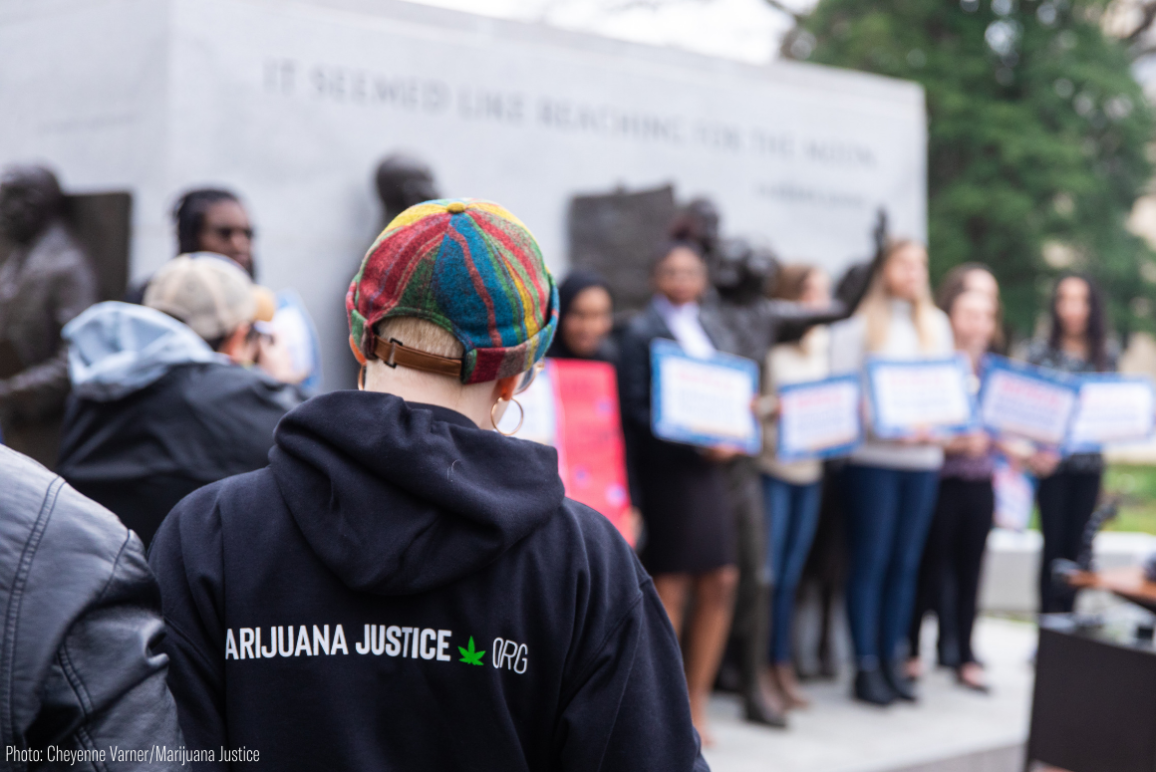 a protester wearing a hoodie with Marijuana Justice logo on