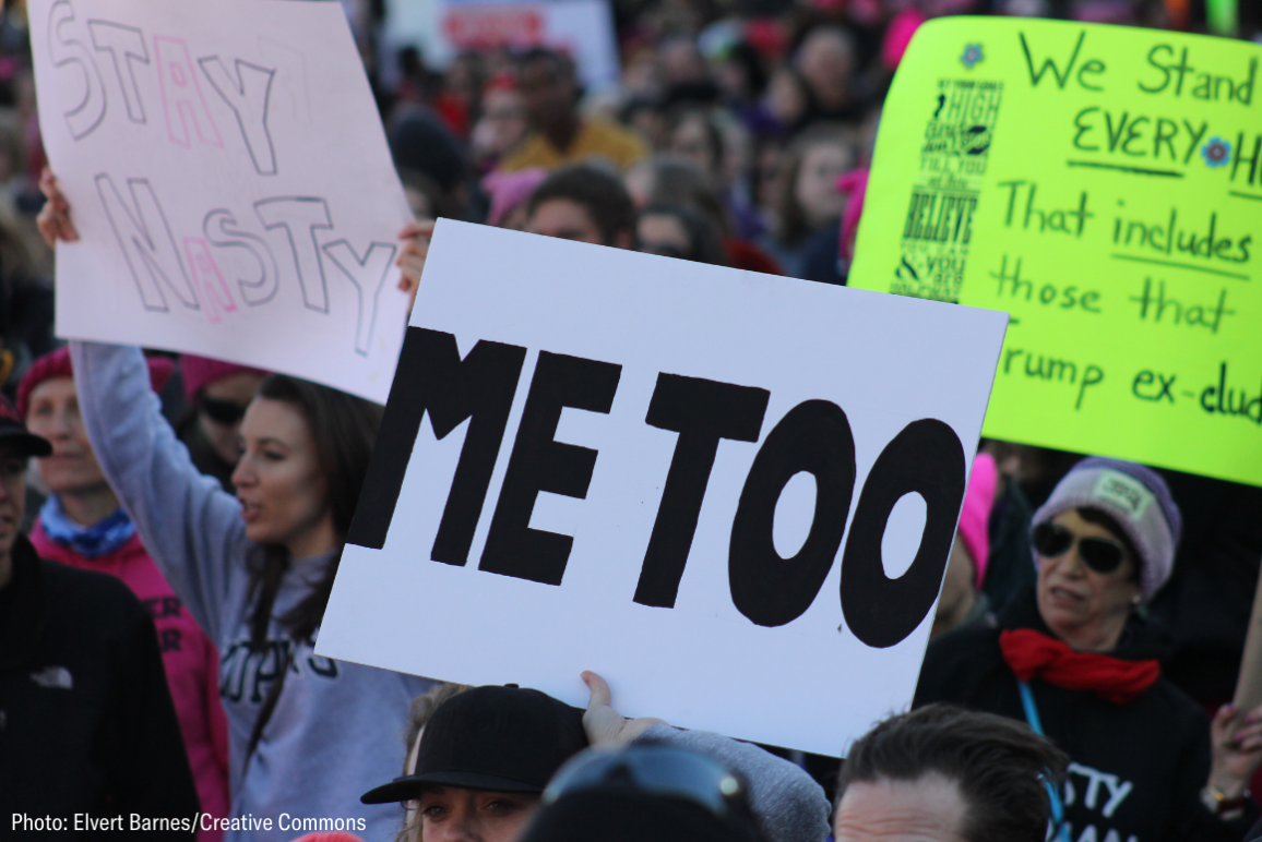 People carrying sign that says "Me Too"