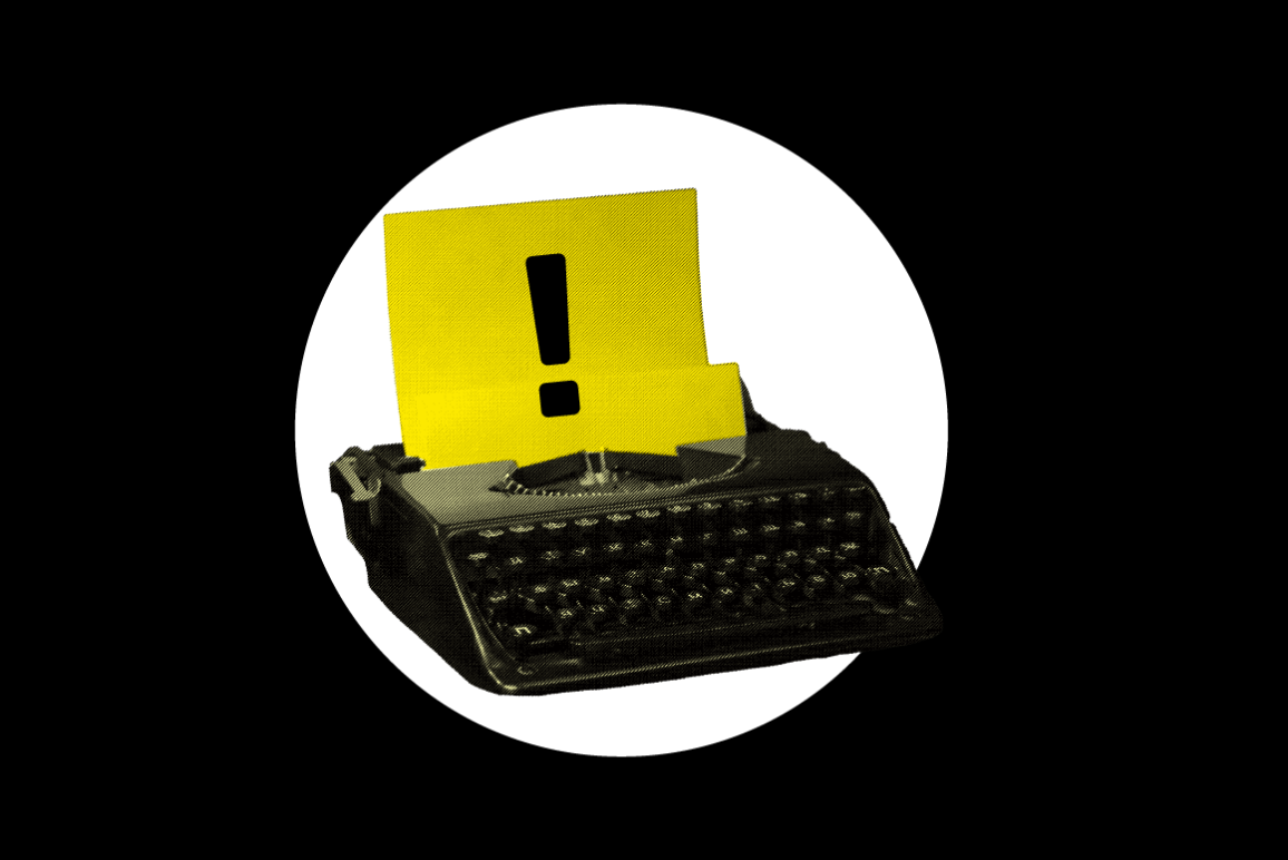 A yellow typewriter with an exclamation point in the paper.