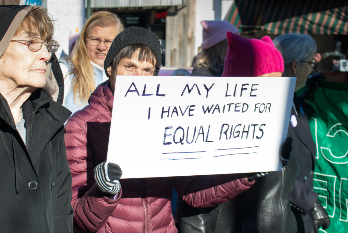 A woman holding a sign that said "All my Life I have waited for equal rights" at the Women's March in Richmond 