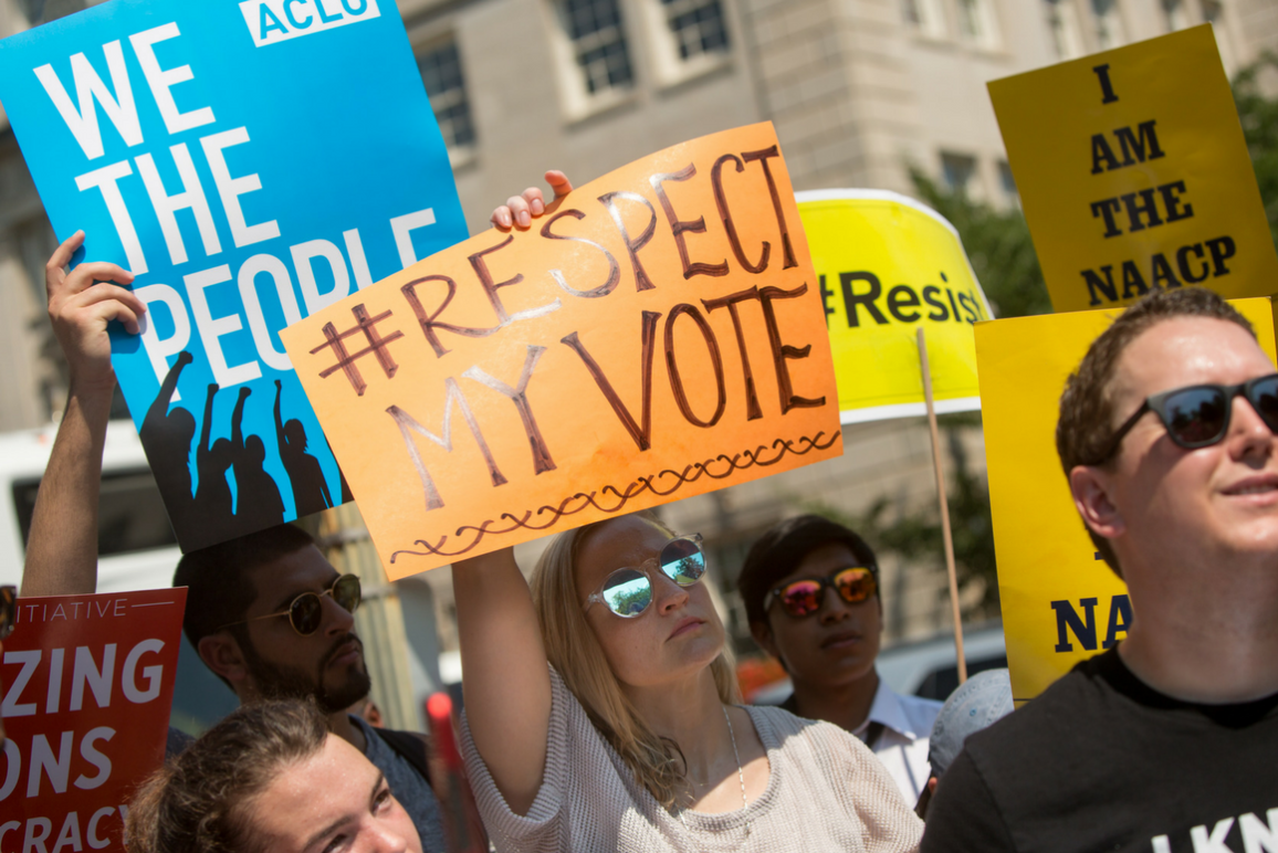 protesters holding signs that say Respect My Vote