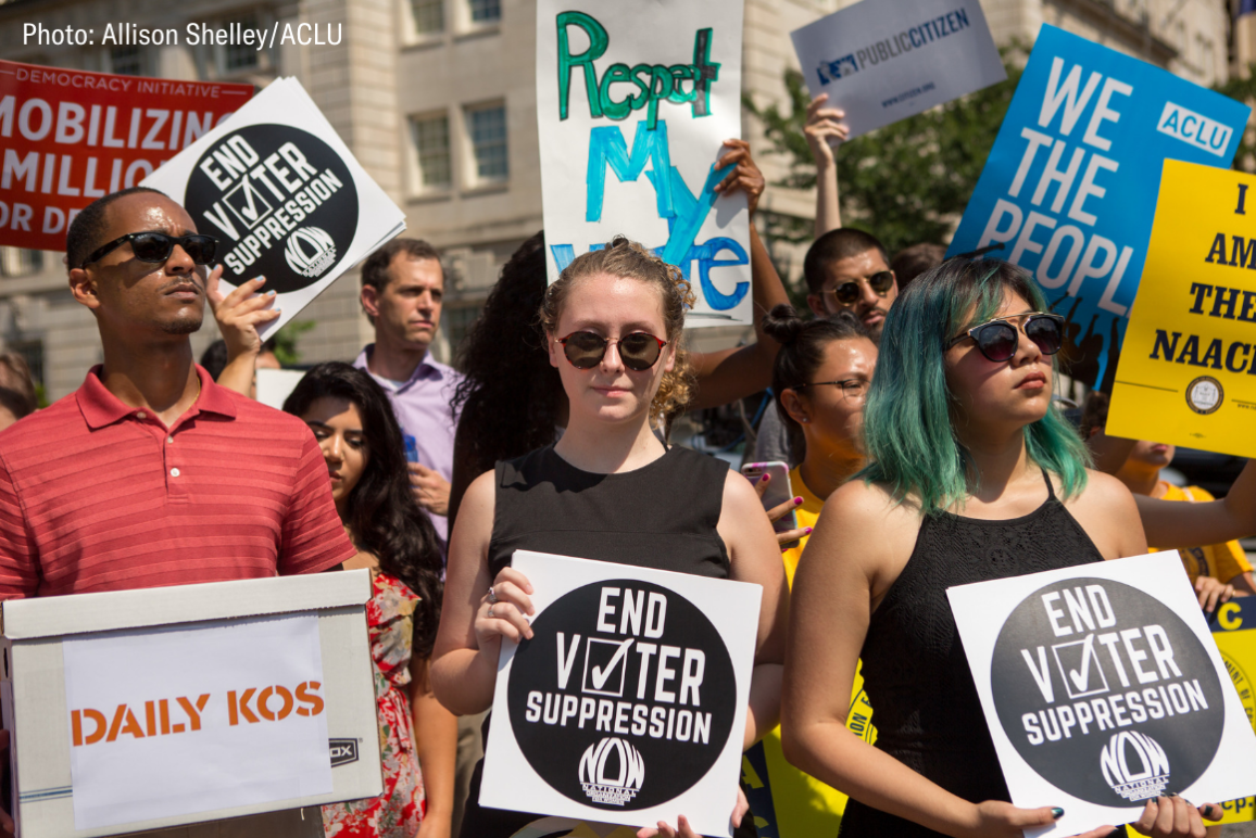 protesters holding signs that say "respect my vote" and "end voter suppression"