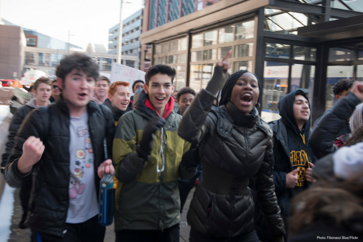 Photo of high school students walking out and protesting