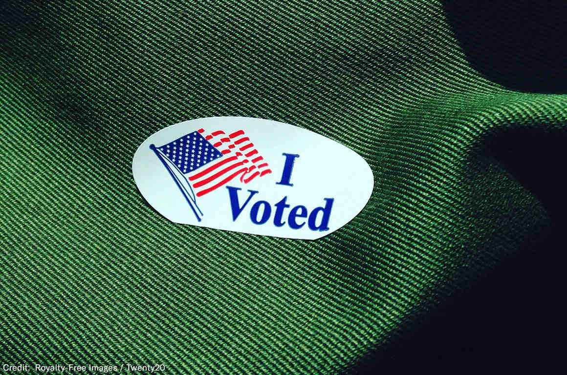 Voting sticker on green fabric