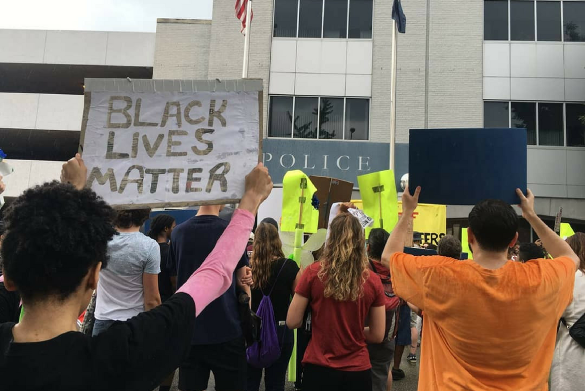 Stephanie Younger, back to the viewer, held a sign that said "Black Lives Matter" while she joined many other protesters in front of Richmond Police headquarter