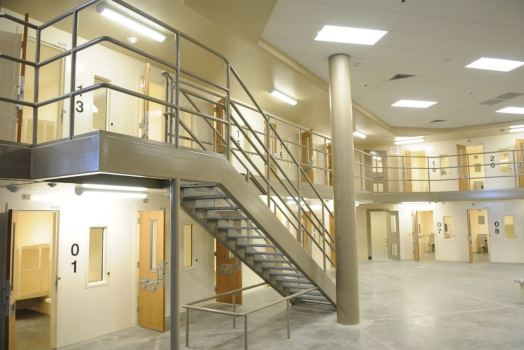 a wide-angle shot of a prison complex, with rows of prison cells