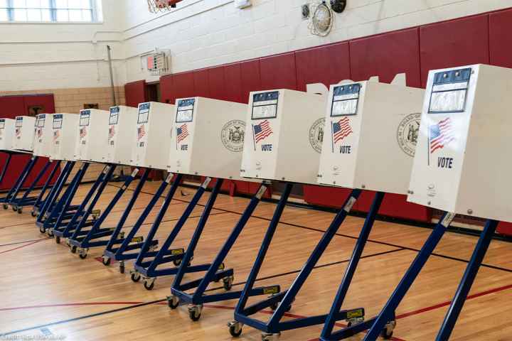 Voting booths lined up at polling station during in a public school in Brooklyn, New York.