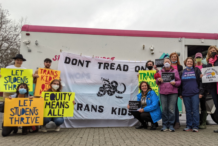 Don't Tread on Trans Kids Hanover (website) (1160 × 775 px).png a group of parents and community advocates standing in front of Studio Two Three truck with a banner in the center that reads "Don't Tread on Trans Kids". Community members held pro-trans rights signs like "Let students thrive" and "Trans kids are our kid