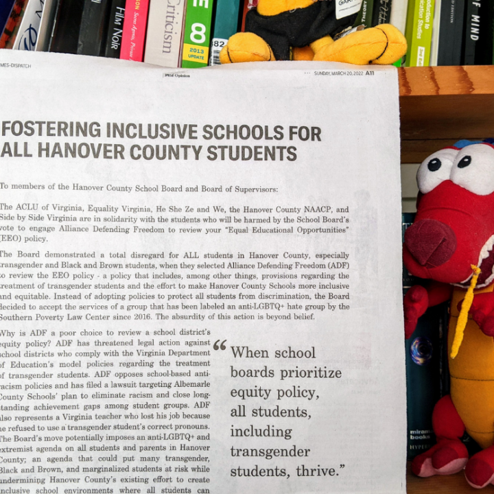 photo of a full-page newspaper opinion ad titled "Fostering inclusive schools for all Hanover County students," with a bookshelf in the background and a stuffed animal (Mushu the red dragon from Disney's Mulan) to the right of the newspapers. 