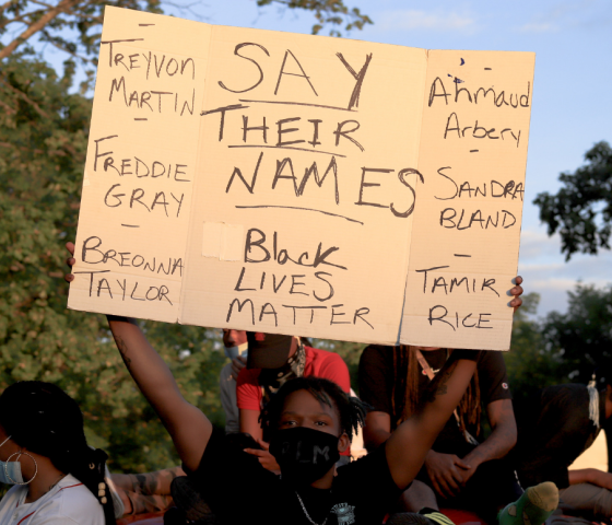 a sign saying "say their names" with the name of Breonna Taylor, Tamir Rice, and so many more